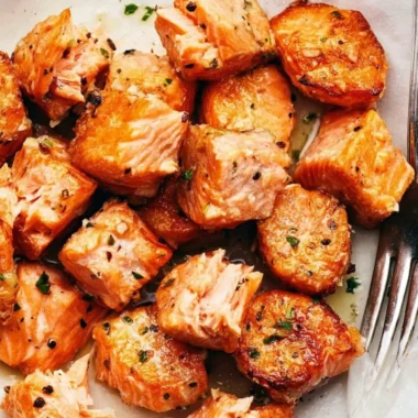 Air fryer salmon bites with lemon garlic butter sauce on a plate