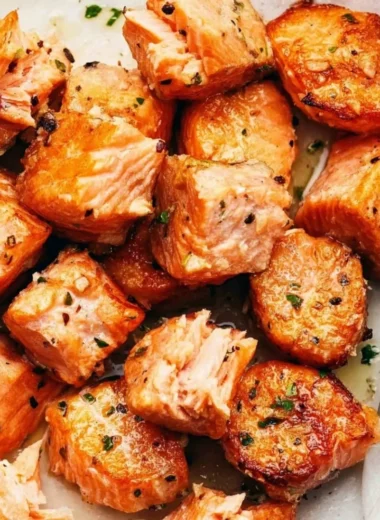 Air fryer salmon bites with lemon garlic butter sauce on a plate