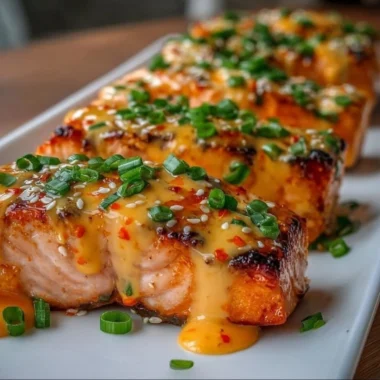 Bang Bang Salmon dish featuring spicy sauce and garnishes.