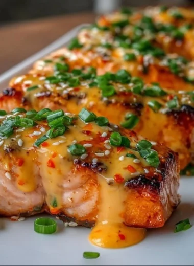Bang Bang Salmon dish featuring spicy sauce and garnishes.