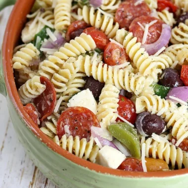 Bowl of colorful classic pasta salad with vegetables and dressing