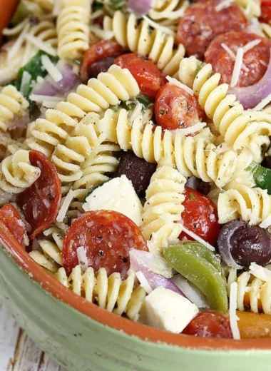 Bowl of colorful classic pasta salad with vegetables and dressing
