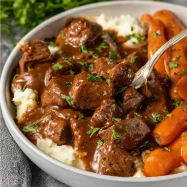 Crock Pot beef tips and gravy served in a bowl with vegetables