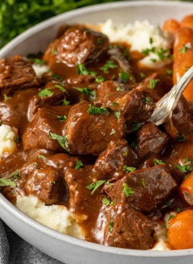 Crock Pot beef tips and gravy served in a bowl with vegetables