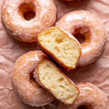Homemade glazed donuts topped with sweet icing on a plate