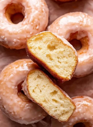Homemade glazed donuts topped with sweet icing on a plate