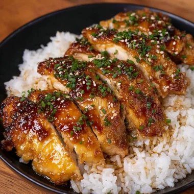 Delicious Honey Garlic Lemon Chicken served on a plate with herbs.