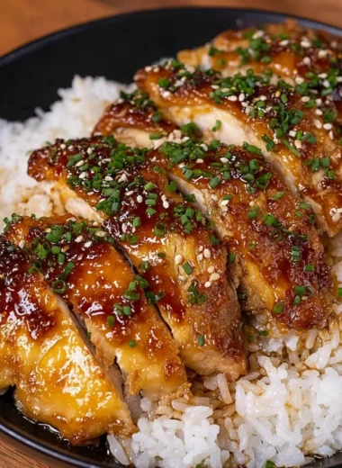 Delicious Honey Garlic Lemon Chicken served on a plate with herbs.