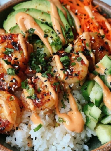 Shrimp rice bowl topped with spicy mayo and fresh vegetables