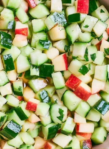 A vibrant Cucumber Apple Salad with fresh ingredients served in a bowl.