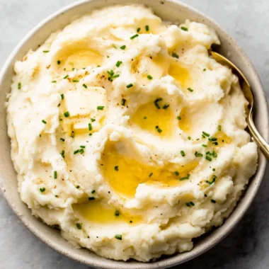 Delicious easy garlic mashed potatoes served in a bowl with herbs