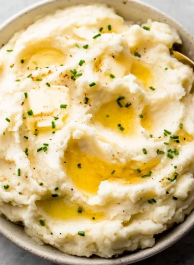 Delicious easy garlic mashed potatoes served in a bowl with herbs