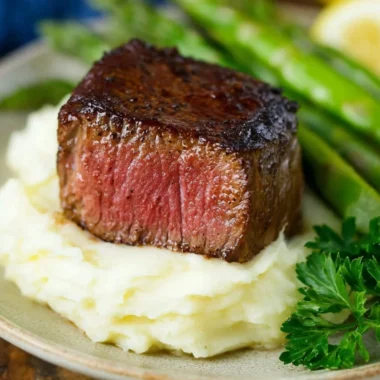Delicious Filet Mignon topped with Garlic and Herb Butter served on a plate