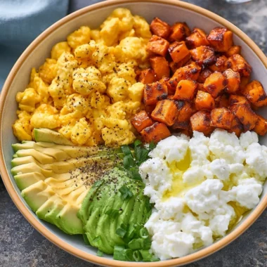 High-protein breakfast bowl with eggs, quinoa, and fresh vegetables