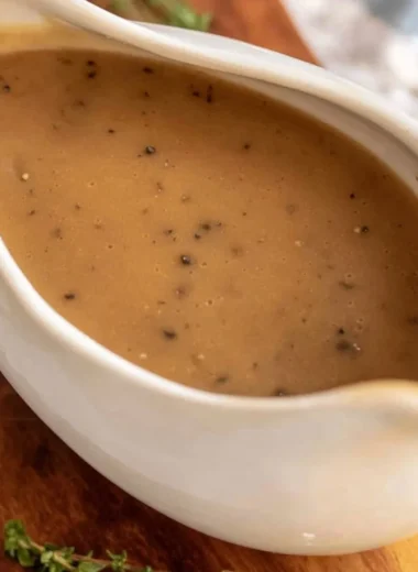 Bowl of homemade brown gravy served over mashed potatoes