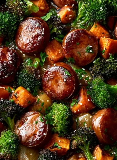 Honey garlic sausage with roasted sweet potatoes on a sheet pan