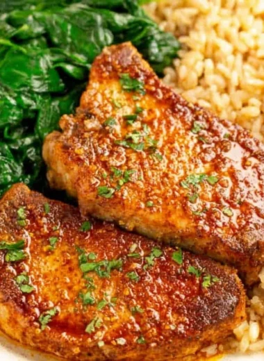 Juicy oven baked pork chops with rice, a delicious and easy recipe.