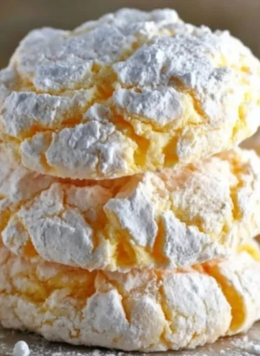Lemon Cool Whip Cookies displayed on a plate, showcasing their bright yellow color and soft texture.