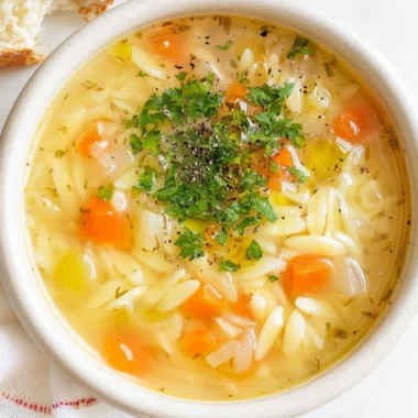A delicious bowl of orzo soup with vegetables and herbs