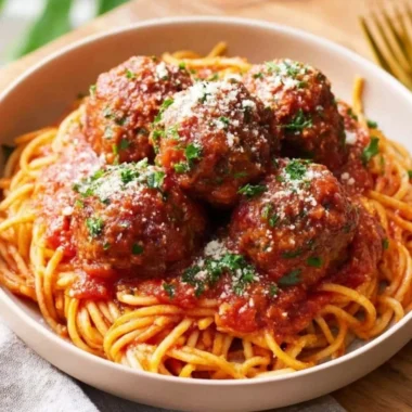 Oven-Baked Italian Meatballs served with sauce and pasta