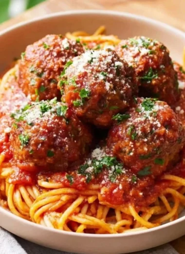 Oven-Baked Italian Meatballs served with sauce and pasta