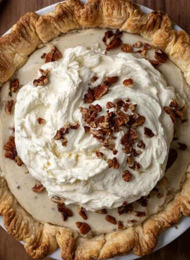 Delicious homemade Pecan Cream Pie topped with whipped cream and pecans