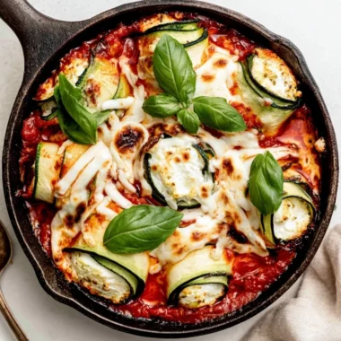 Ricotta stuffed zucchini roll-ups garnished and ready to serve