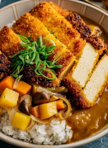 Crispy tofu cutlet served with fresh vegetables on a plate