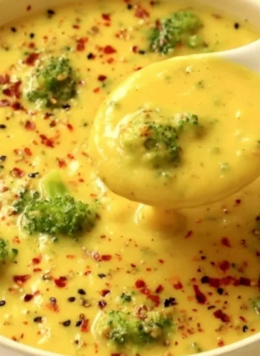 Vegan broccoli potato soup served in a bowl with fresh herbs on top