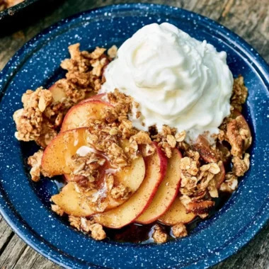 Vegan Campfire Apple Crisp dessert served outdoors