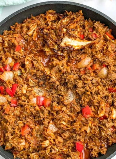 Plate of African Cabbage Stew with Ground Beef garnished with fresh herbs