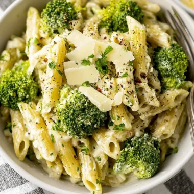 Creamy garlic pasta with broccoli served in a white bowl