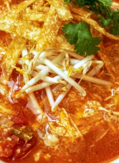 Delicious Crock Pot Chicken Tortilla Soup served in a bowl with crispy tortilla strips.