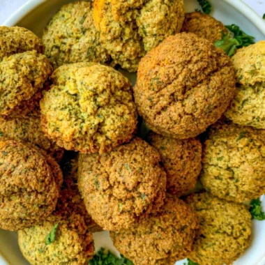 Plate of golden crispy falafel served with tahini sauce and salad