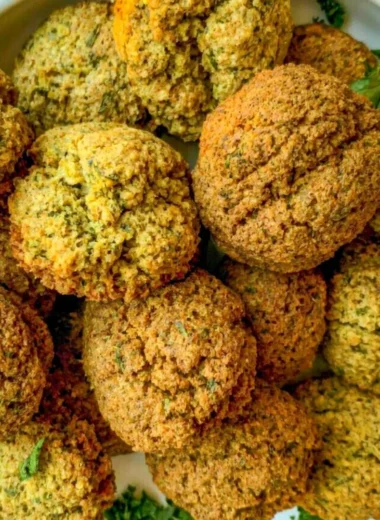 Plate of golden crispy falafel served with tahini sauce and salad