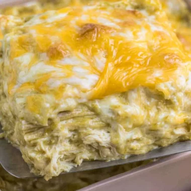 Delicious green chili chicken enchiladas topped with cheese and herbs