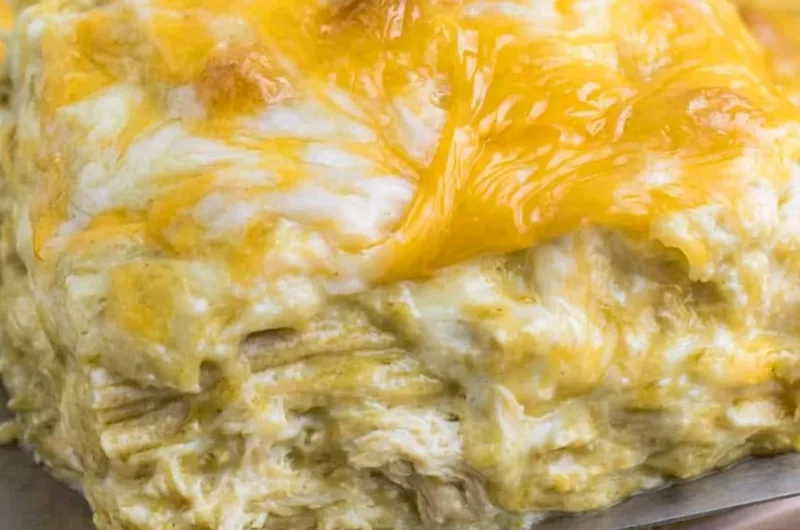 Delicious green chili chicken enchiladas topped with cheese and herbs
