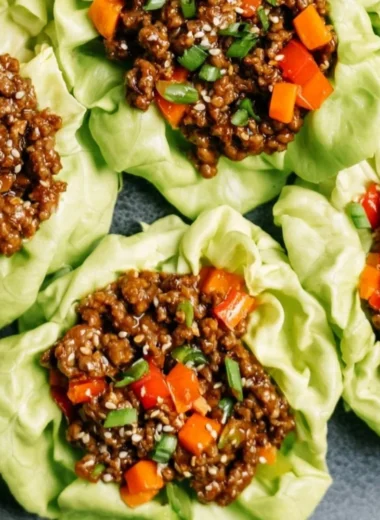 Plate of Ground Beef Lettuce Wraps with fresh vegetables and sauce