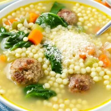 Bowl of traditional Italian Wedding Soup with meatballs and greens