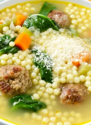 Bowl of traditional Italian Wedding Soup with meatballs and greens