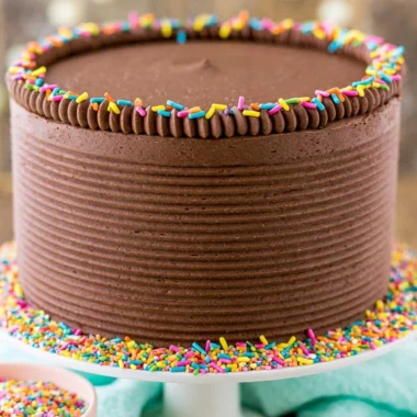 Moist yellow cake with chocolate frosting on a decorative plate