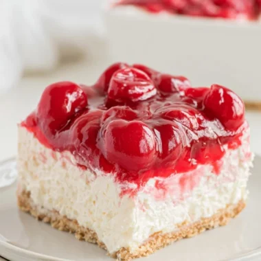 No Bake Cherry Cheesecake topped with fresh cherries and whipped cream