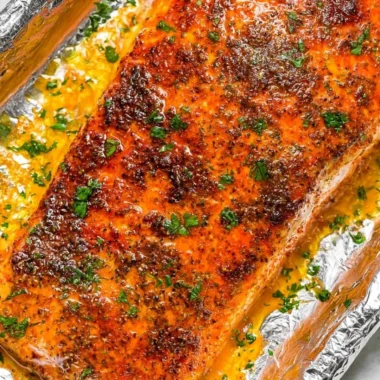Delicious oven baked salmon fillet served with herbs and lemon
