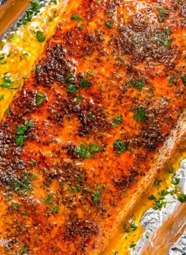 Delicious oven baked salmon fillet served with herbs and lemon