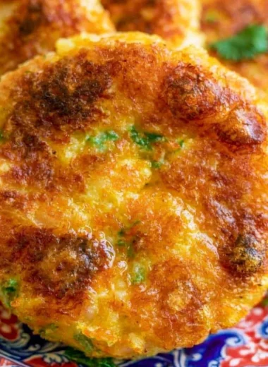 Crispy potato cutlet served with chutney on a plate.