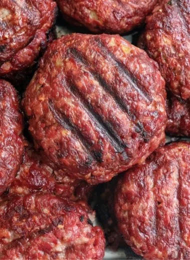 Delicious smoked burgers grilling on a barbecue