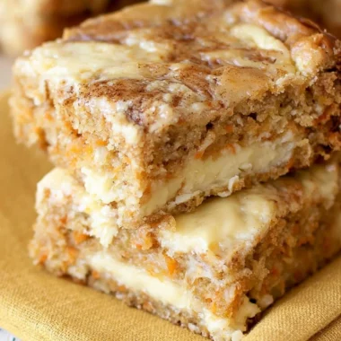 Delicious homemade carrot cake bars topped with cream cheese frosting.