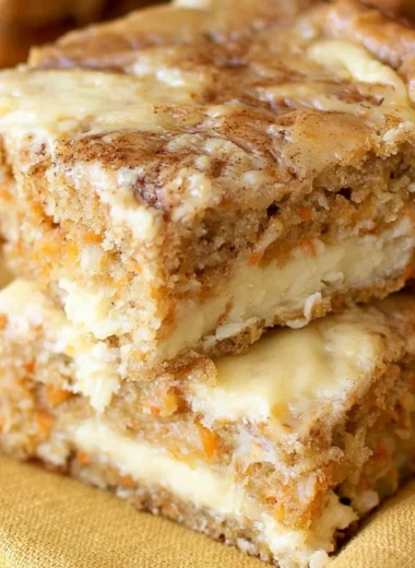 Delicious homemade carrot cake bars topped with cream cheese frosting.