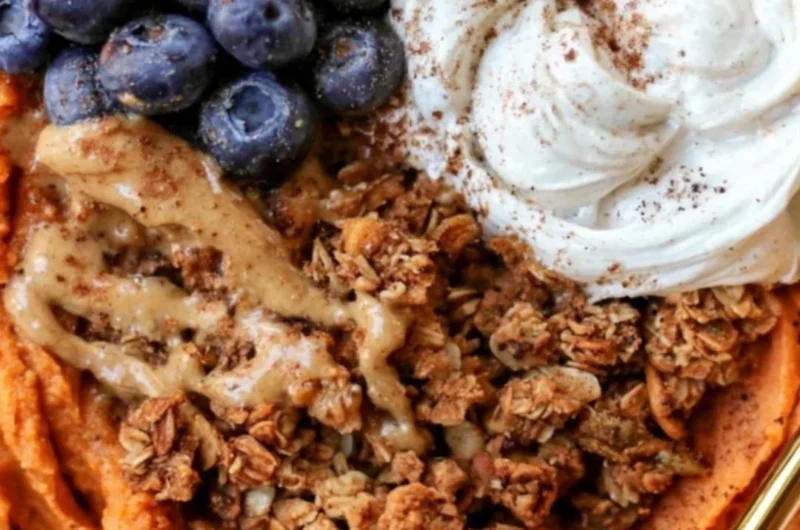 Fluffy sweet potato breakfast bowl topped with nuts and fruits